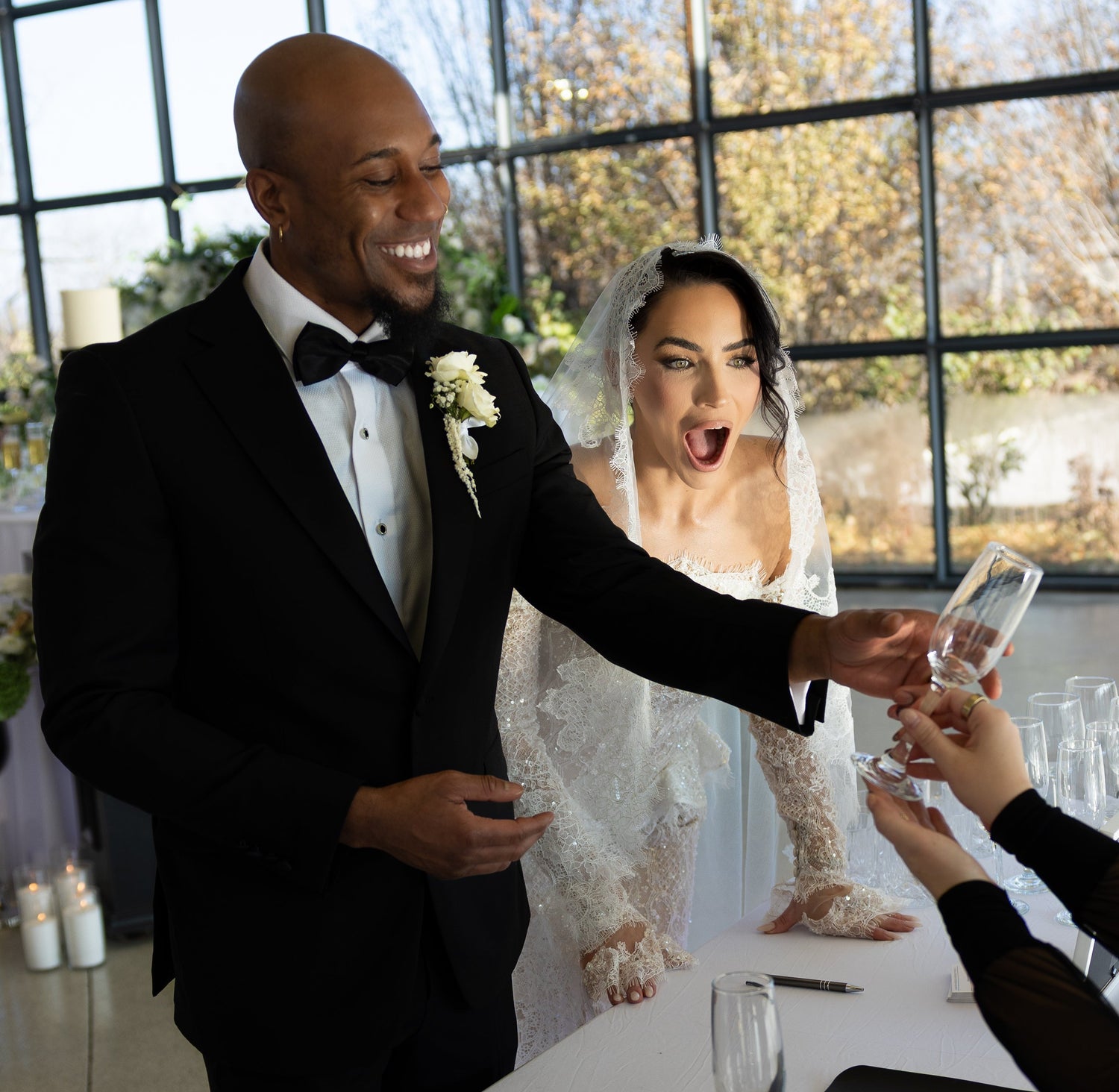bride and groom receiving custom engraved champagne glass at wedding reception in kansas city