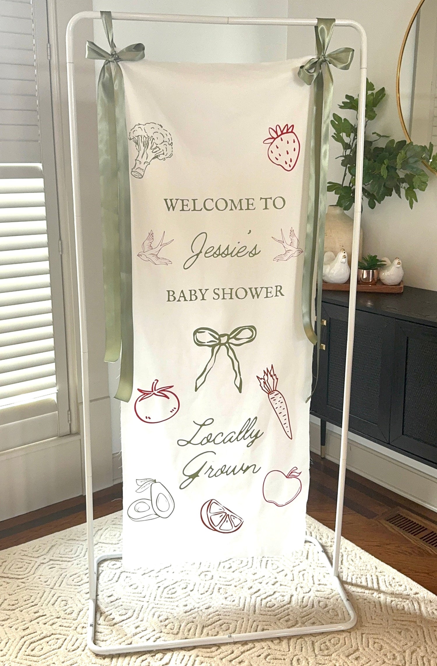 Baby shower welcome sign with decorative elements on a stand. White metal sign stand rental for Kansas City wedding