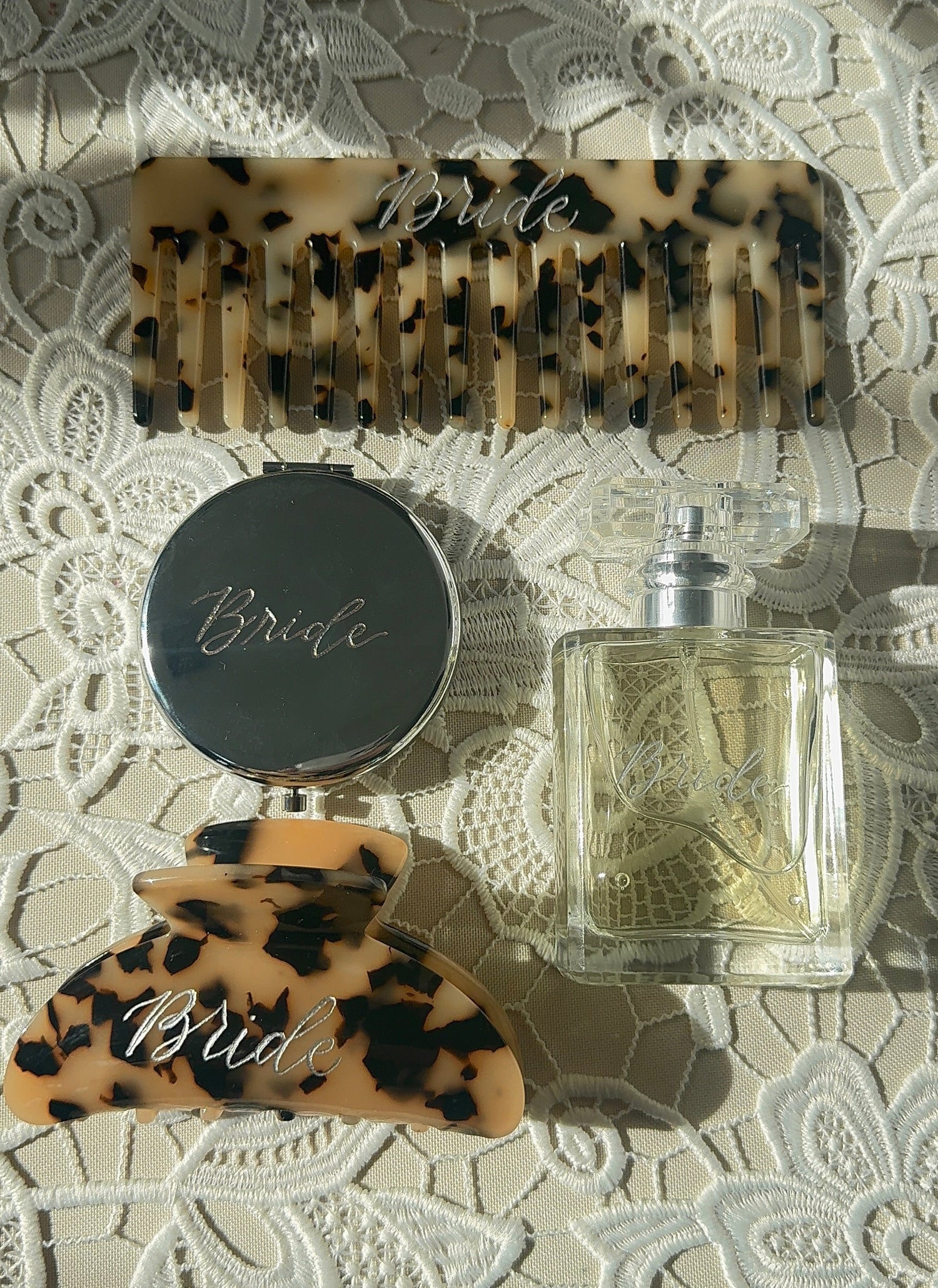 Bride accessories including personalized comb, compact mirror, and perfume bottle — custom wedding gifts Kansas City