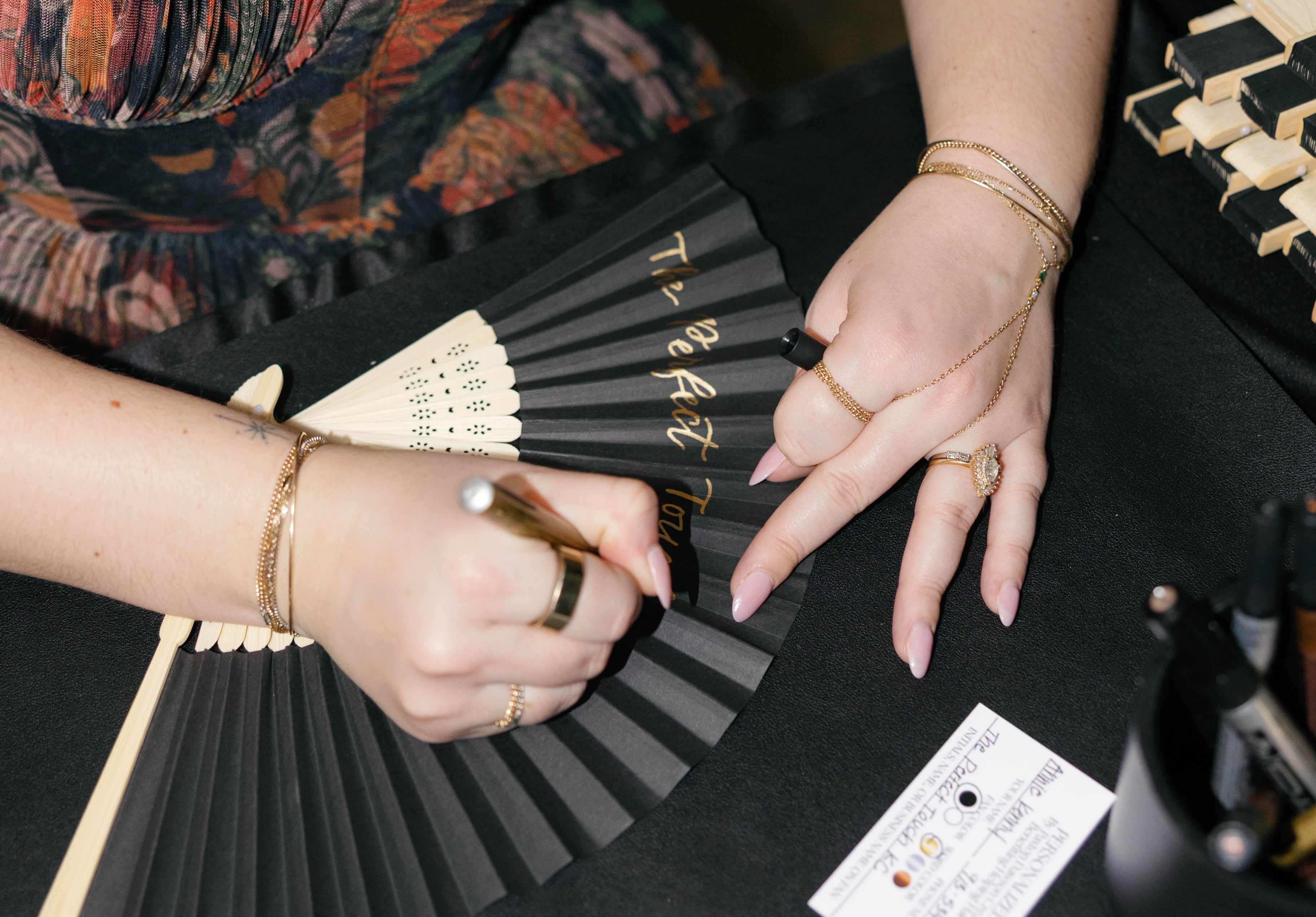 Calligraphy on paper fans at corporate gala in kansas city